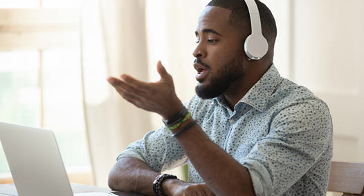 person wearing headphones at a computer
