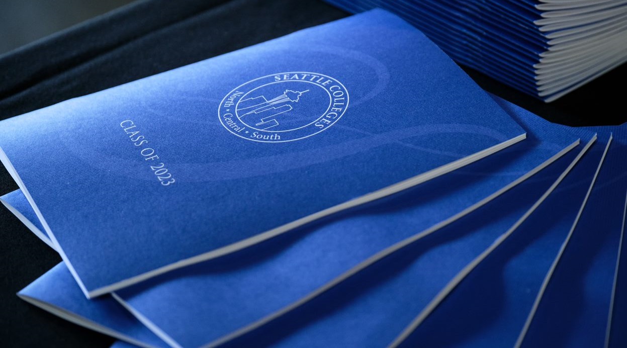 stack of commencement programs fanned out on a table