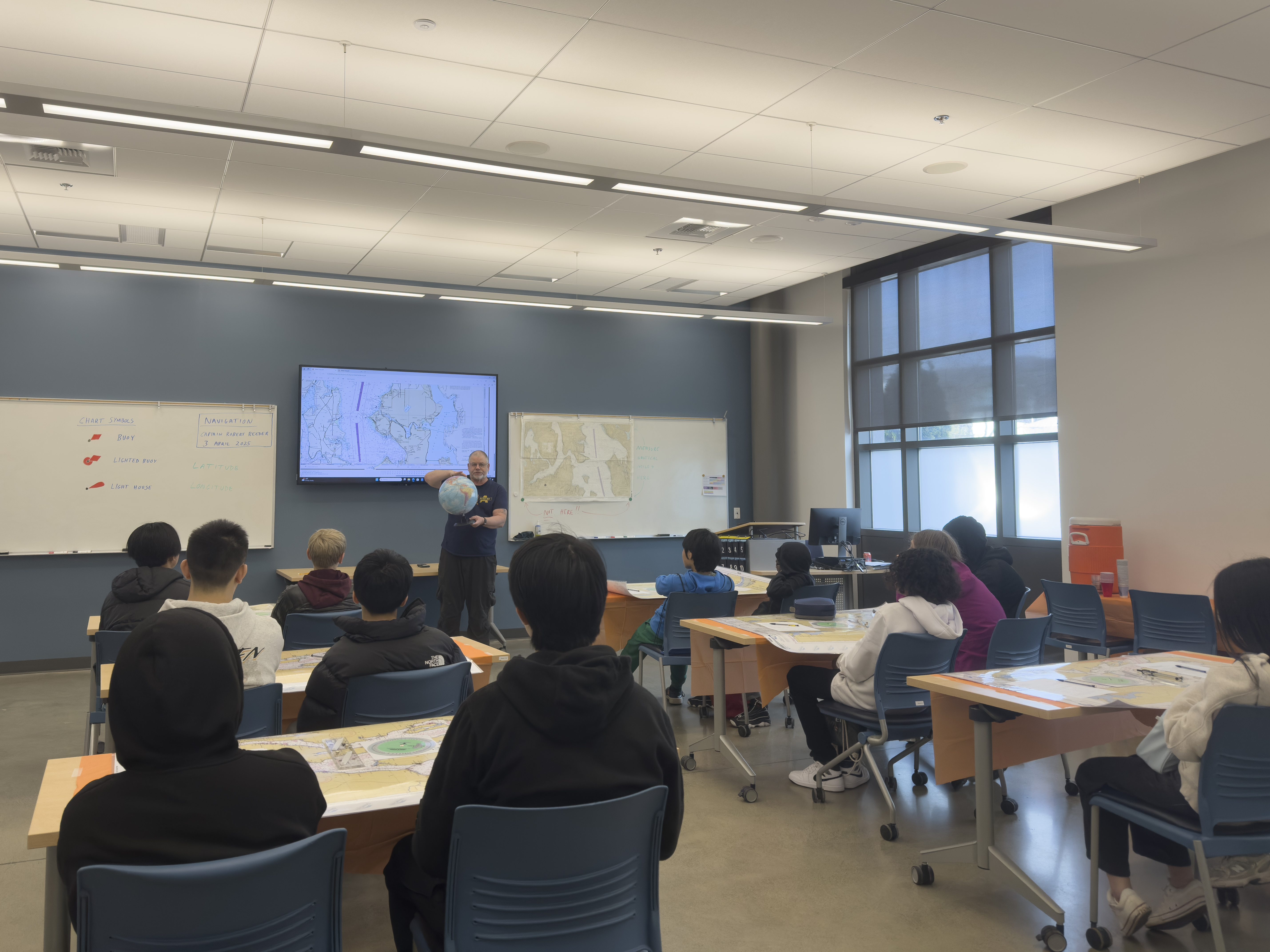Captain Robert Reeder teaching about navigation fundamentals, at one of the four activities hosted at Seattle Maritime Academy