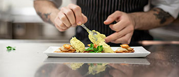 student placing food on plate